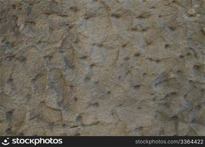 background jagged sandstone wall. background or texture of a jagged sandstone wall