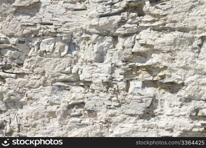 background jagged white stone wall. background or texture of a jagged white stone wall