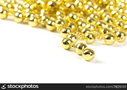 Background made of a brilliant celebratory beads of golden color over white