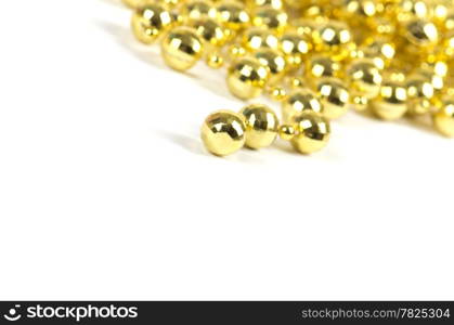 Background made of a brilliant celebratory beads of golden color over white