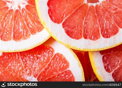 background made with a heap of sliced grapefruits