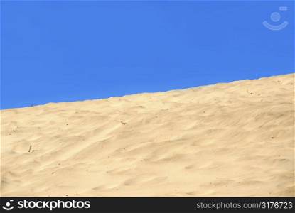 Background of a sand dune with clear blue sky