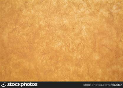 background of amber textured handmade mulberry paper