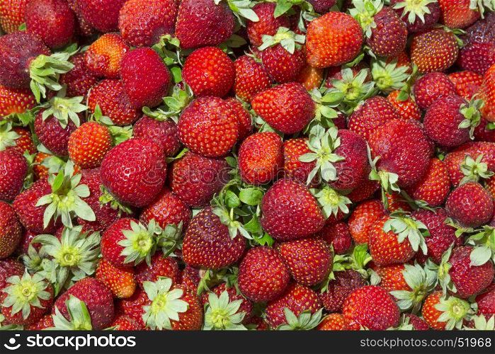 Background of beautiful and juicy strawberries with green leaves. Background of beautiful and juicy strawberries with green leaves.