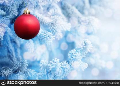 Background of Big Red Christmas Ball on the Christmas Tree with Snow in the Frozen Winter Day