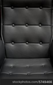Background of black a leather armchair. Background leather armchair