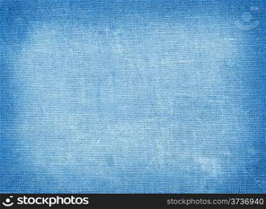 Background of blue coarse textiles with tinted edges