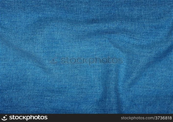 Background of blue denim with long folds