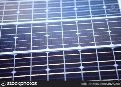 background of blue solar photovoltaic panels, charging batteries. Renewable eco energy concept