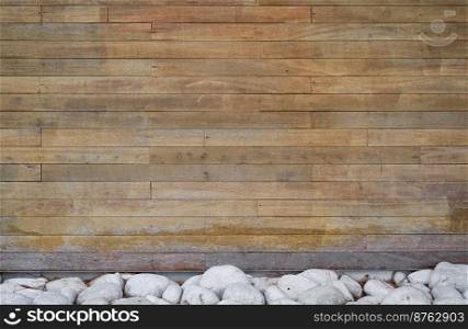 Background of boards and decor of stones on the bottom of the wall, interior design idea. Advertising screen made of natural materials