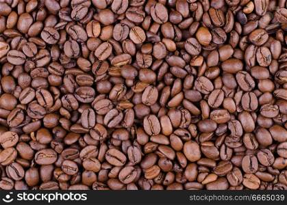 Background of coffee beans. Dropped brown coffee beans.