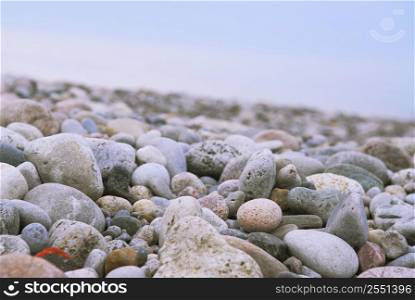 Background of colofrul beach pebbles of different shapes and water