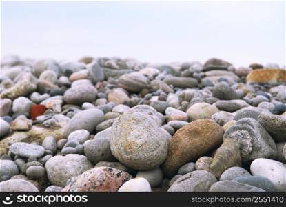 Background of colofrul beach pebbles of different shapes and water