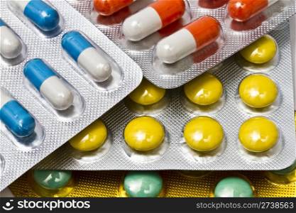 Background of colorful capsules and pills closeup