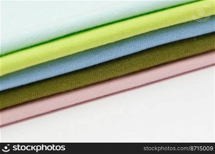 background of colorful fabrics and textiles stacked on one another. backgrounds of fabrics and textiles