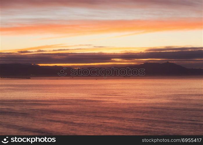 Background of colorful sky and ocean landscape. Dramatic sunset with twilight color sky and clouds.
