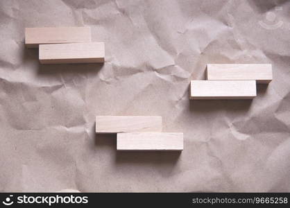 background of crumpled craft paper with wooden rectangles arranged in a certain order in a minimalist style