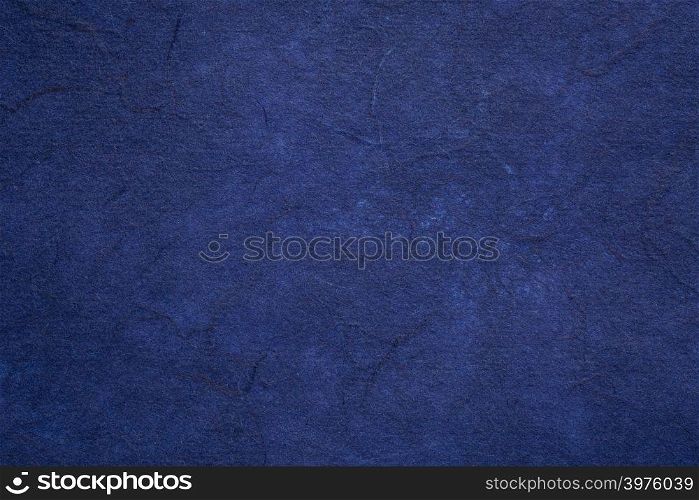 background of dark blue textured handmade mulberry paper
