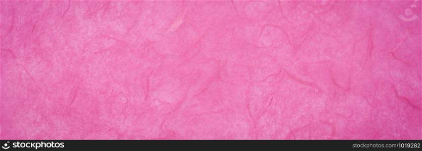 background of dark pink, textured, handmade mulberry paper, panoramic banner