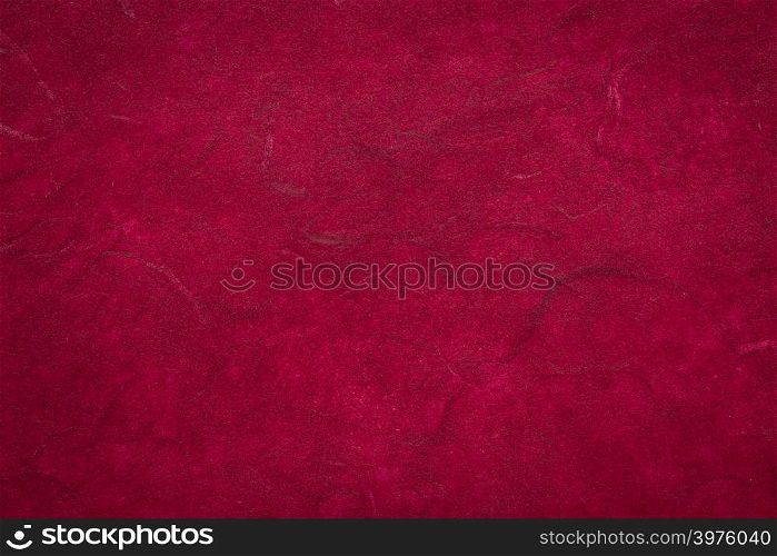 background of dark red textured handmade mulberry paper