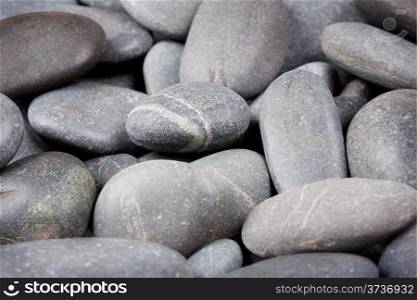 Background of dark round small sea stones