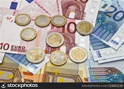 Background of different euro currency and coins closeup