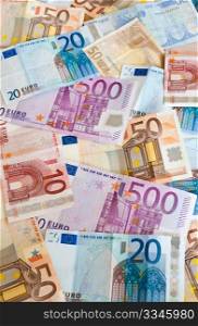 Background of euros: ten, twenty, fifty and five-hundred euro banknotes.