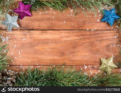 Background of fir branches and cones on a wooden background