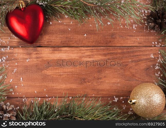 Background of fir branches and cones on a wooden background