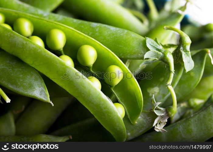 background of fresh green peas on a wooden table