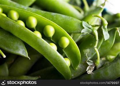 background of fresh green peas on a wooden table