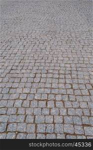 Background of gray granite cobblestone pavement