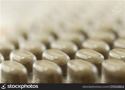 Background of herbal supplement pills close up