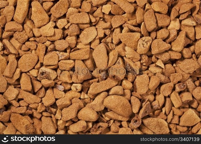 background of instant coffee granules at life-size magnification
