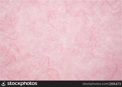 background of light pink, textured, handmade mulberry paper