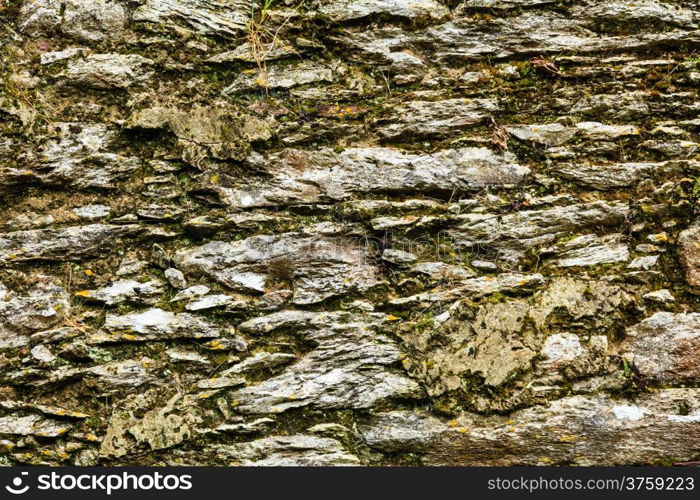 Background of natural gray stone wall texture rough rock surface