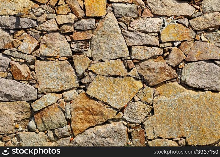 Background of natural stone rock wall texture or cobblestone pavement detail