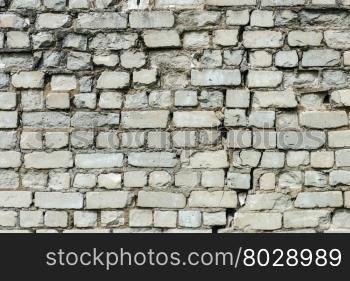 Background of old cracked white brick wall