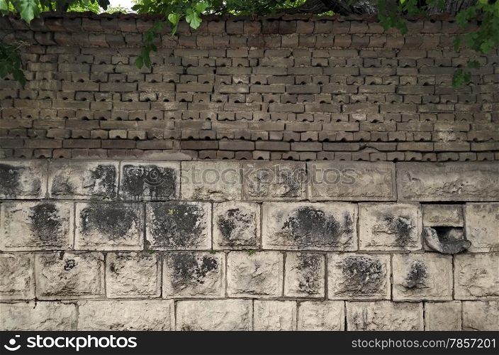 Background of old tiled fence from stone and brick, Razgrad, Bulgaria
