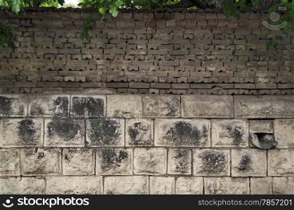 Background of old tiled fence from stone and brick, Razgrad, Bulgaria