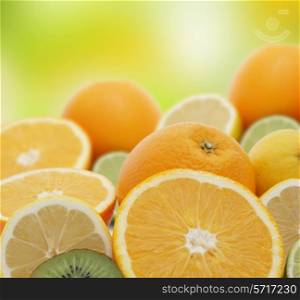 Background of oranges, lemons, limes and kiwi