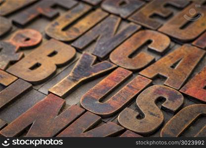 background of random vintage letterpress wood type printing blocks stained by color inks