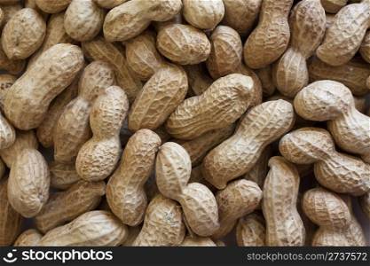 Background of raw peanuts in shell.
