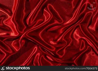 Background of red satin fabric. Shiny silk backdrop. 