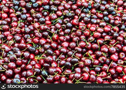 Background of ripe cherries in the farmer market