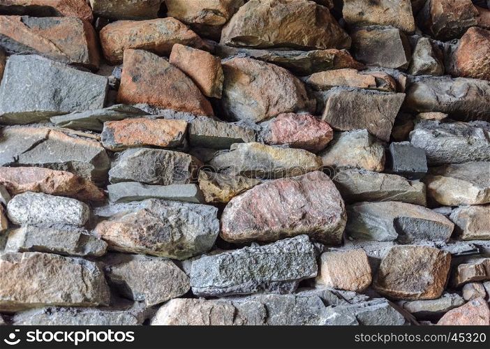 Background of rough stones wall with cement mortar