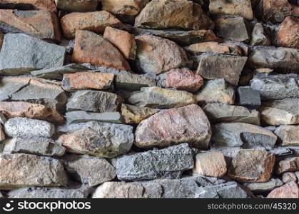Background of rough stones wall with cement mortar
