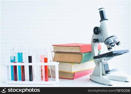 Background of Science equipments, test tubes, books and microscope with copy space. Education Concept.
