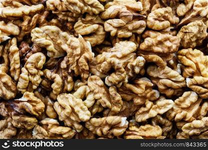 Background of shelled dried walnuts in close-up (high details)