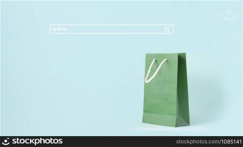 Background of shopping online concept. Search engine input box or web address bar. Green shopping bag on mint pastel color background.